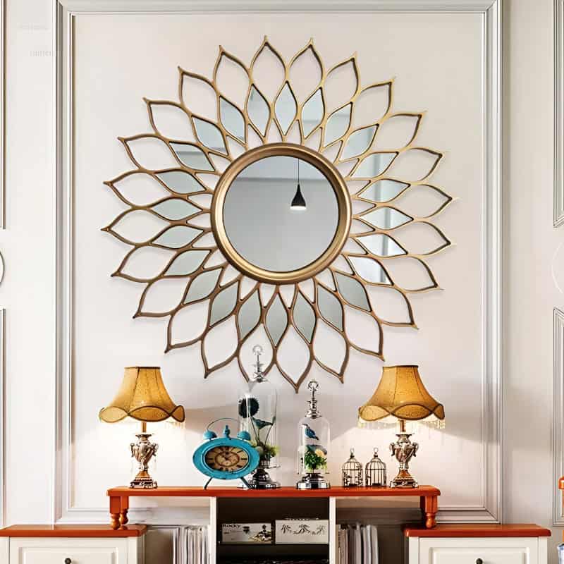 Decorative round mirror with gold petal frame in elegant interior decor for home aesthetic enhancement.