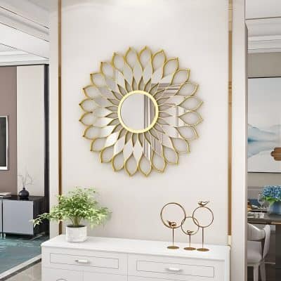 Elegant gold decorative mirror with a sunburst design for stylish home decor and interior design accents. Perfect for living rooms, bedrooms, or entryways.