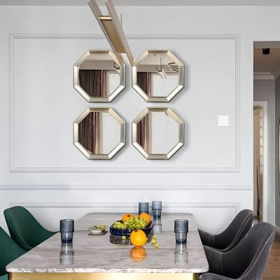 Elegant dining room with modern decor, featuring four stylish wall mirrors and a marble table set with glasses and fresh fruit, perfect for a contemporary home or upscale space.
