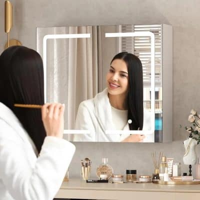 Elegant woman applying makeup in front of vanity mirror, featuring beauty products, skincare essentials, and a stylish, modern setting at Monalisa Store.