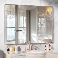 Elegant bathroom vanity with large mirror, luxurious crystal chandelier, and natural light for a stylish and functional space.