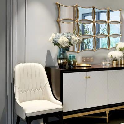 Elegant interior with a modern white chair, stylish black and white sideboard, floral decor, and a decorative mirror, creating a luxurious ambiance perfect for an optometry or optical store setting.