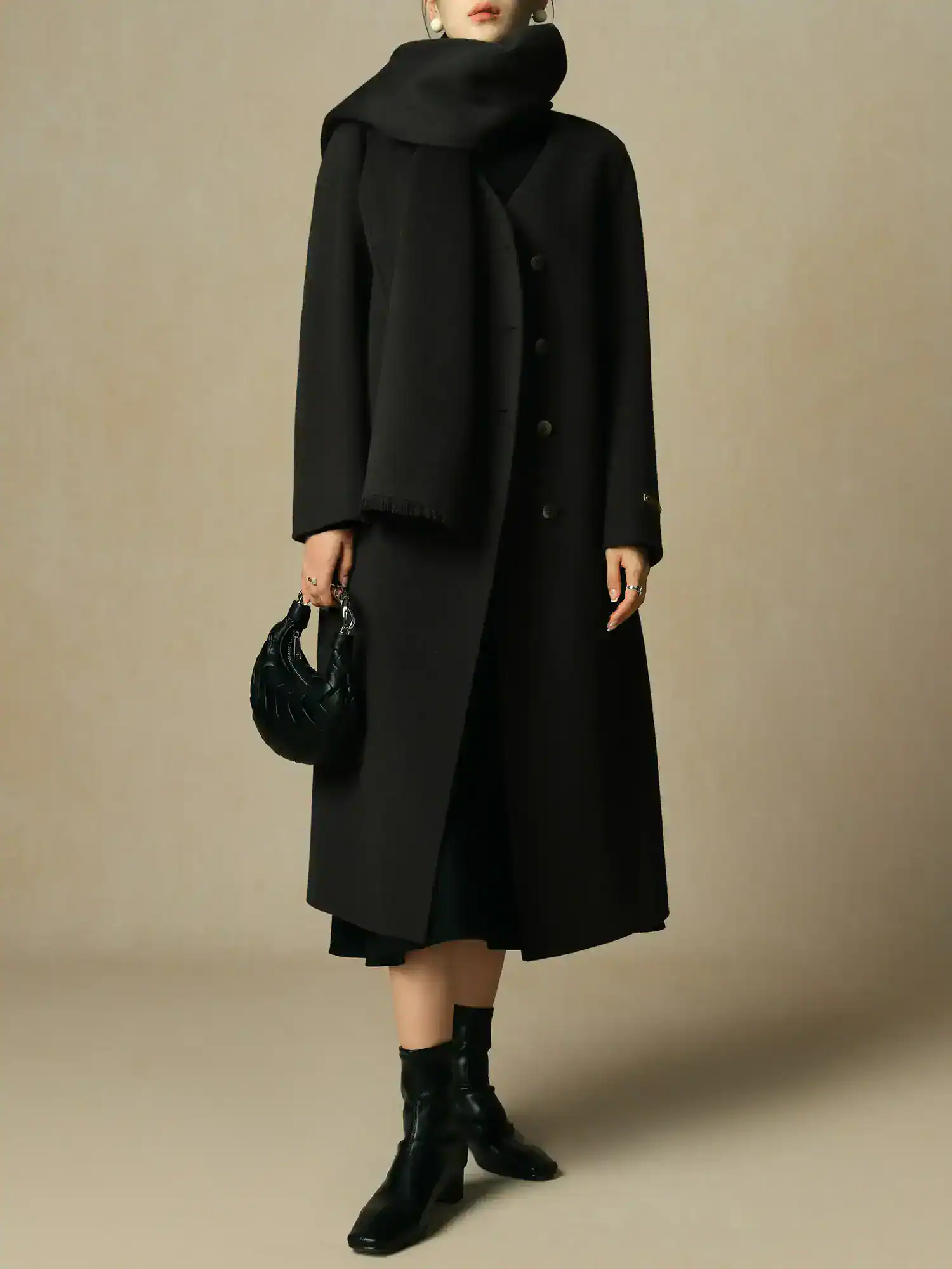 Elegant black coat with oversized scarf and stylish black boots, perfect for winter fashion and winter outerwear. Monalisa Store offers high-quality women's clothing and accessories.