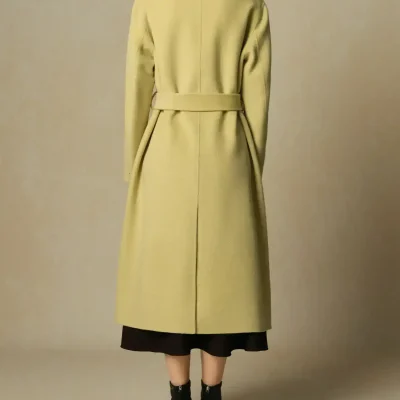 Elegant beige long coat with a belted waist, designed for women, featuring a stylish and luxurious look suitable for fashion-forward individuals. Perfect for fall and winter wear.