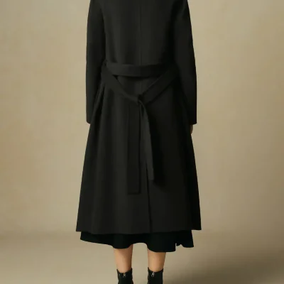 Modern black trench coat with a waist belt, stylish and elegant outerwear perfect for fall and winter fashion.