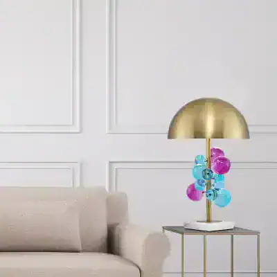 Colorful glass bubble table lamp with gold finish on a modern side table in elegant living room decor.