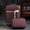 Elegant maroon travel luggage set with cream accents, ideal for business trips and vacations, featuring durable materials and smooth-rolling wheels for easy mobility.