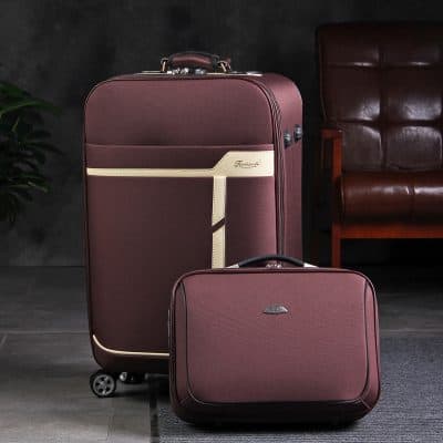 Elegant maroon travel luggage set with cream accents, ideal for business trips and vacations, featuring durable materials and smooth-rolling wheels for easy mobility.