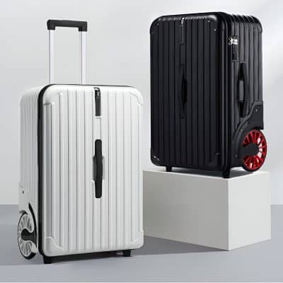 White and black hard-shell rolling luggage sets with telescopic handles and spinner wheels, modern travel suitcases for business and leisure trips, displayed on a white platform and plain background.