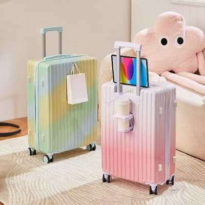 Pastel-colored hard shell suitcases with telescoping handles and wheels, suitable for travel, displayed indoors at Monalisa Store.