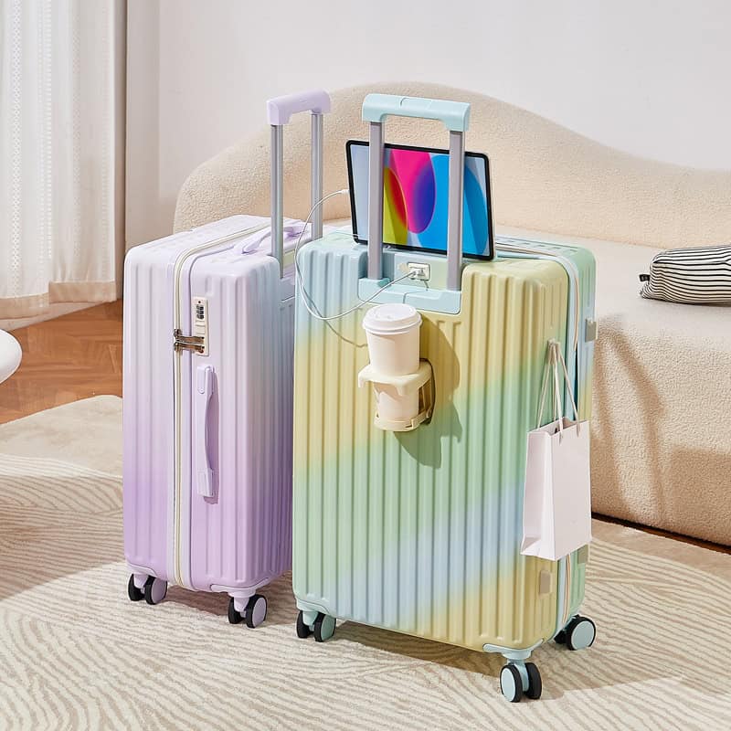 Purple and pastel yellow hard-shell suitcases with telescoping handles and built-in TSA locks, set in a cozy living room with a beige sofa and striped pillow, highlighting travel essentials for modern travelers.