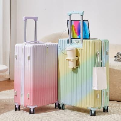 Pink and pastel rainbow hard-shell suitcases for travel, with integrated electronic devices, travel accessories, and monalisa store branding for trendy luggage options for travelers.