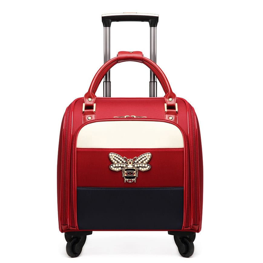 Red stylish rolling luggage bag with bee and logo embellishment, perfect for travel and modern accessories.