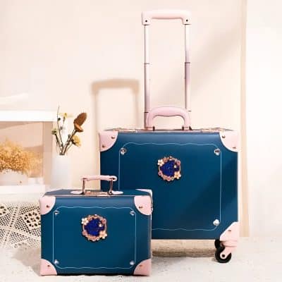 Pink and blue monalisa store luggage set with floral embellishments for travel and cosmetics.