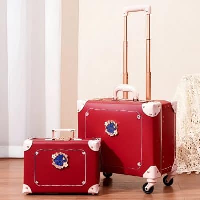 Vibrant pink and red Monalisa luggage sets with decorative embellishments, perfect for travel in style, featuring durable construction, smooth wheels, and a chic design for fashionable travelers.