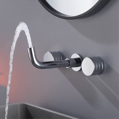 Faucet with running water on a modern gray sink, close-up shot.