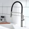 Brushed stainless steel kitchen faucet with black rubber hose and modern design, mounted on white tiled wall backdrop. Perfect for contemporary kitchen decor and water efficiency.