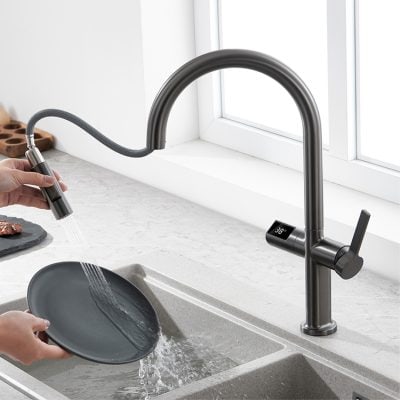 Sleek modern kitchen faucet with digital temperature display near a window, installed over a stone sink for optimal cleaning and style.