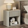 Miniature beige nightstand with vertical textured drawer front, beige table lamp, candles, decorative yarn balls, and books, modern bedroom decor, Monalisa Store opt.