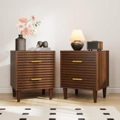 Mid-century modern wooden nightstands with slatted drawer fronts and gold handles, decorated with contemporary lamps, vases, and accessories, ideal for stylish bedroom or living room decor.