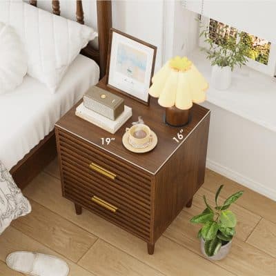 Elegant wooden bedside table with brass handles, 19 inches wide and 16 inches tall, perfect for bedroom decor with cozy lamp and plant, ideal for home storage and stylish living spaces.