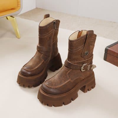 Brown leather fashion boots with chunky soles and buckle details, perfect for stylish winter wear.