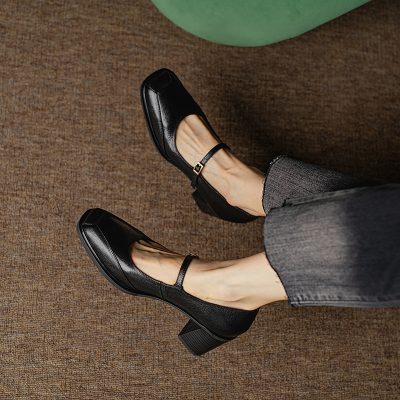 Comfortable black Mary Jane shoes with block heels, perfect for professional or casual wear, showcased on a brown textured carpet. Stylish footwear options available at Monalisa Store.