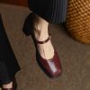 Shoe by Monalisa Store featuring elegant maroon leather with ankle strap and chunky heel, perfect for professional and casual wear.