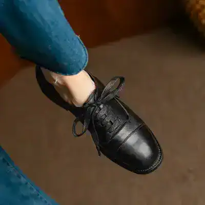 Black leather dress shoe with laces, stylish and comfortable, perfect for formal occasions and office wear.