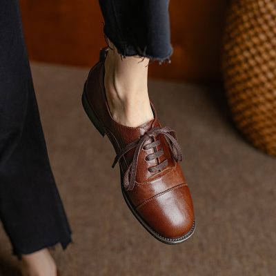 Brown leather dress shoe for women, stylish and comfortable footwear perfect for formal and casual occasions.