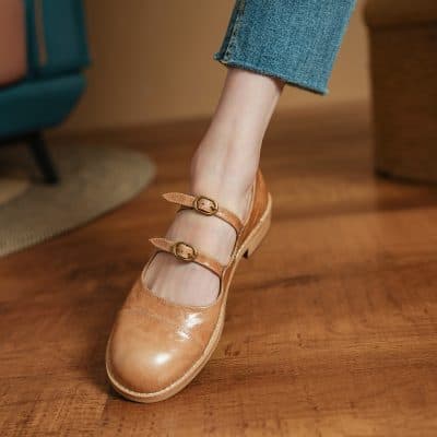 Handmade leather Mary Jane shoes with double straps on wooden floor. Elegant and comfortable footwear, ideal for casual or formal wear, available at Monalisa Store.