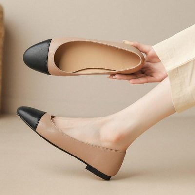 Comfortable beige and black women's flats with a rounded toe for stylish casual wear in opt clinic setting.