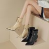 Stylish high-heel ankle boots with pointed toes, available in beige and black, showcased in a modern fashion setting for elegant footwear and trendy shoe shopping.