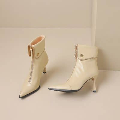 Cream leather ankle boots with zipper detail and pointed toe, stylish footwear for women.