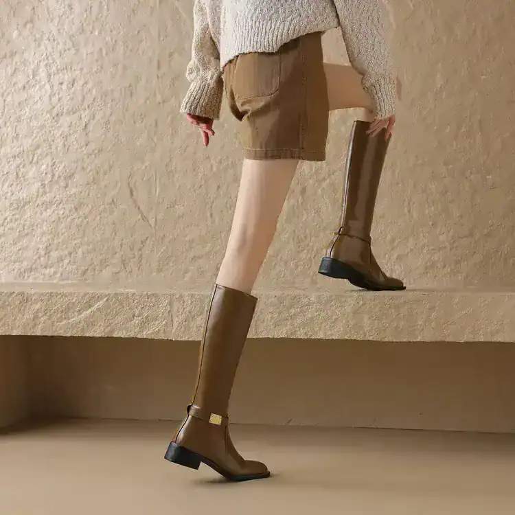 141263-425f4e.jpg - Monalisa Store Elegant knee-high leather boots displayed on a model, perfect for fall and winter fashion, showcasing Monalisa store’s premium footwear collection.