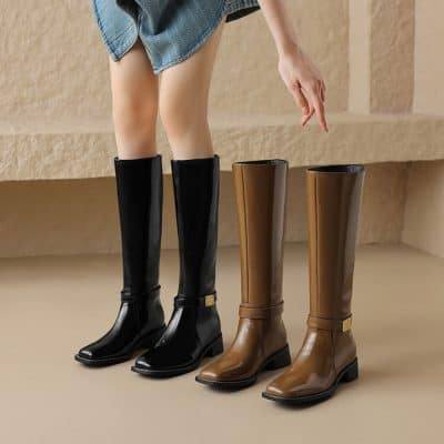 Glossy black and brown knee-high leather boots displayed at Monalisa Store, perfect for fashion-forward footwear shopping. The stylish boots feature sleek design and comfortable heels for versatile wear.