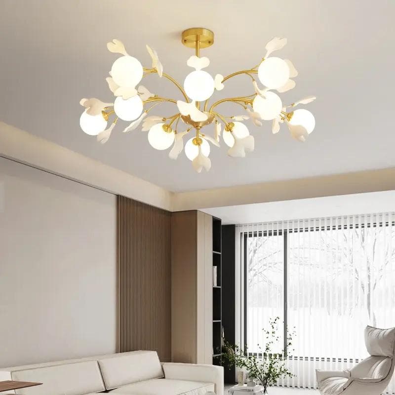 Elegant gold and white floral chandelier in modern living room with natural light, stylish design perfect for contemporary homes, enhancing interior decor at Monalisa Store.