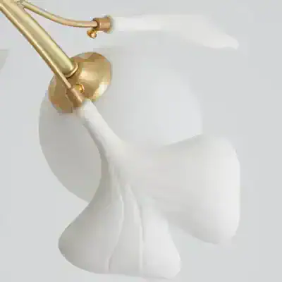Gold and white faucet with flowing water for luxury bathroom decor.