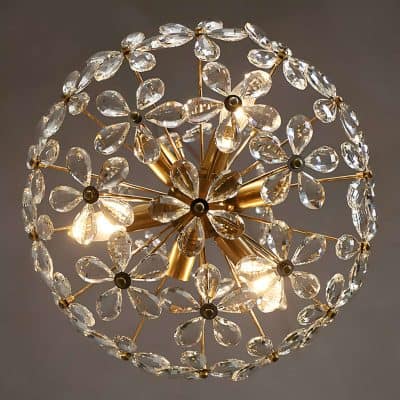 Elegant crystal chandelier with gold accents and intricate detailing, perfect for upscale home decor and luxury decor accents. Ideal for adding a touch of sophistication to any room or event.