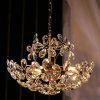 Crystal chandelier with floral design, elegant gold hardware, luxurious lighting fixture for home decor.