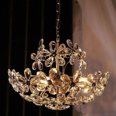 Crystal chandelier with floral design, elegant gold hardware, luxurious lighting fixture for home decor.