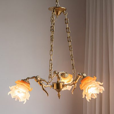 Gold chandelier with floral-shaped glass lamps, elegant interior lighting for homes and living spaces, featuring a sophisticated design with decorative chains and floral accents.