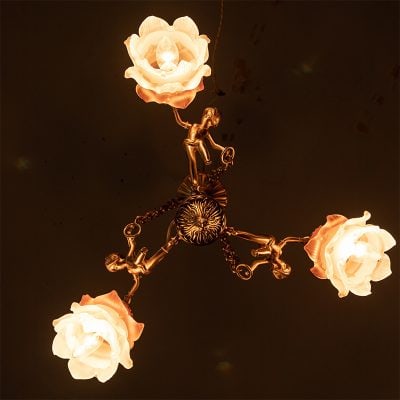 Elegant chandelier with floral-lamp designs and bronze accents, ideal for enhancing upscale interiors and lighting beautiful spaces.