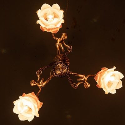 Ornate chandelier with flower-shaped light fixtures, elegant ceiling lighting for opt clinics and aesthetic spaces.