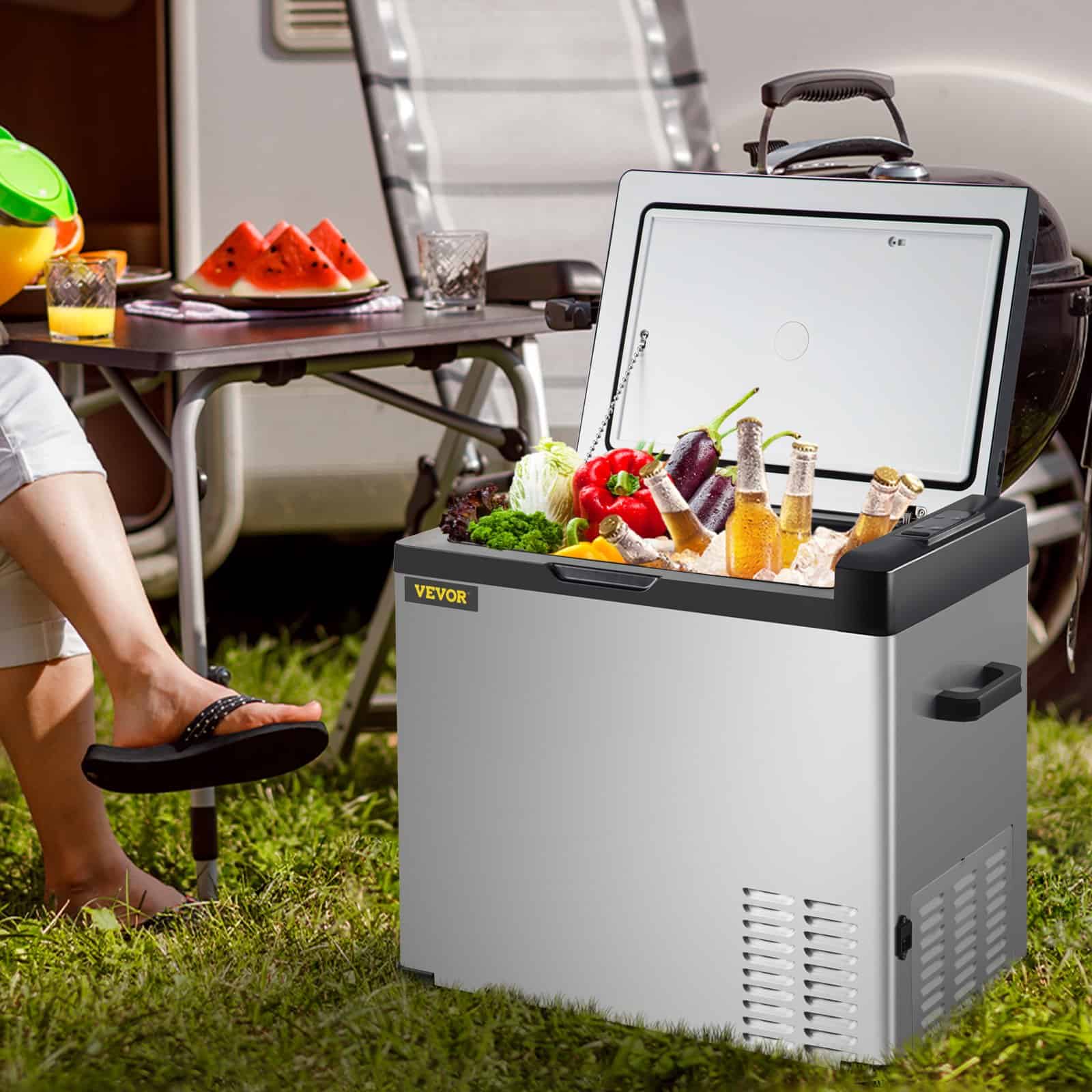 Stainless steel portable mini fridge with freezer compartment, ideal for storing beverages, snacks, and groceries outdoors or at events. Perfect for modern kitchens, offices, and camping trips.