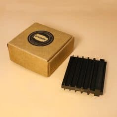 Compact black stainless steel hair clipper guard with a cardboard storage box, ideal for professional and home hair styling, part of Monalisa Medical's grooming accessories.