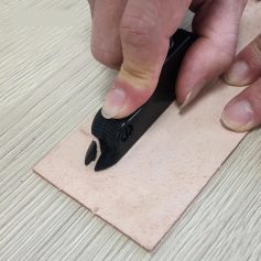Precise leathercraft stitching tool in use, demonstrating professional craftsmanship for high-quality leather and fashion accessories at Monalisa Store.