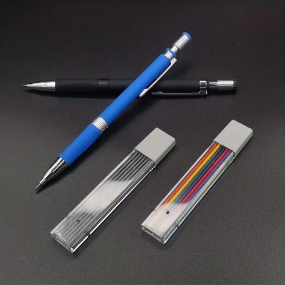 Blue and black retractable ballpoint pens with textured grips and metal clips on a black surface, alongside two transparent storage cases containing colorful stationery supplies, perfect for office or school use.