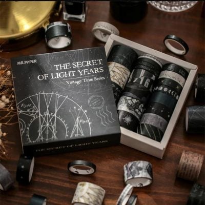 Black washi tapes with celestial and astronomy designs in a gift box at Monalisa Store for decorative craft projects.