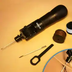 Precision leather stitching tool kit for bags, wallets, and accessories, includes seam roller, awl, thread spools, and strap cutter for professional leatherwork.